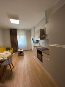 a kitchen and living room with a table and a couch at Perla Blu House in La Spezia
