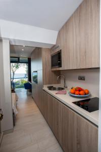 a kitchen with a plate of oranges on a counter at Sounio Sea View in Sounio