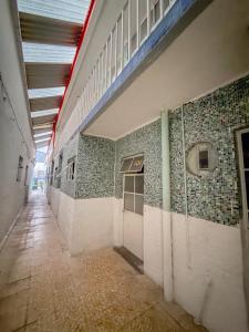 an empty hallway of a building with tiles on the wall at Los Olivos in Atlixco