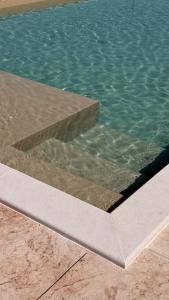 a pool of water with a concrete slab in front of it at Feudi di Bisaccia in Montenero di Bisaccia