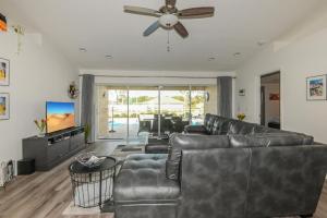 a living room with a couch and a ceiling fan at Withlacoochee Trail Getaway - Private Pool - 3bedrooms in Inverness