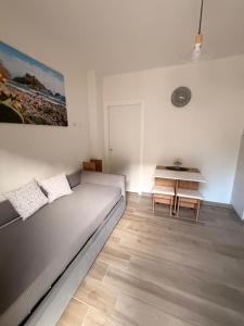 a living room with a bed and a table at Taormina beach apartment in Taormina