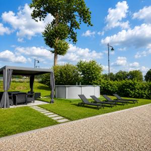 a group of chairs and a picnic shelter in a park at Grafitowe Apartamenty in Czarna Góra