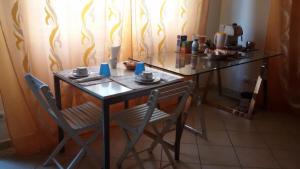 a table with two chairs and a table with cups on it at Il Mirto in Viareggio