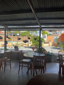 a patio with tables and chairs and a courtyard at Pousada Villa Sítio in Campina Grande