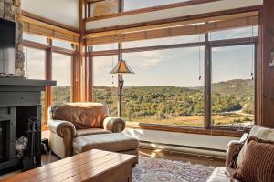 a living room with a large window with a view at Tremblant Prestige - Altitude 172-11 in Mont-Tremblant