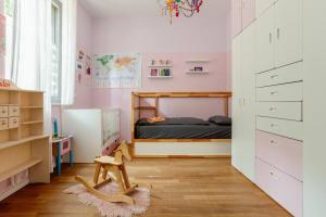 a childs bedroom with pink walls and a bed at Helenas place in Berlin