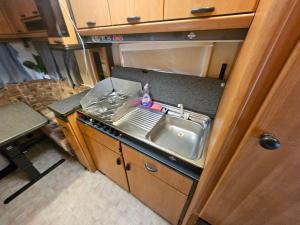 an empty kitchen with a sink and a sink at Full Service Caravan 3 in Søborg