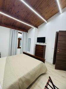 a bedroom with a bed and a wooden ceiling at TBS House in Alghero