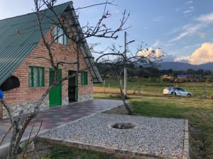 a brick house with a fire pit in front of it at La cabaña in Sotaquirá