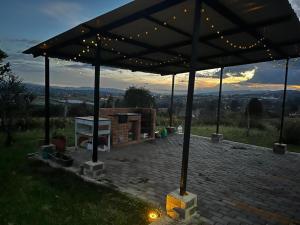 a pavilion with lights on top of a brick patio at La cabaña in Sotaquirá