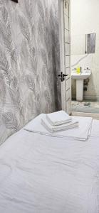 a white bed in a bathroom with a sink at Cheap Hotel in Center in Tashkent +215 photos