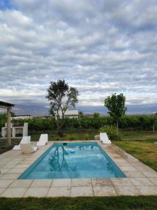 a swimming pool with two lounge chairs at Finca Rosablanca Casa Jazmin in Vista Flores