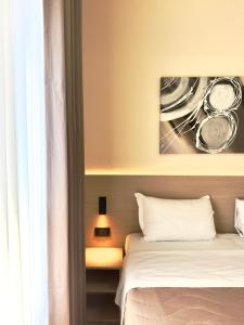 a bedroom with two beds and a painting on the wall at Hotel Molise 2 in Milan +46 photos
