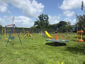 a playground with many different types of play equipment at Villa Toscana in Maturín