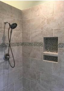 a shower with a shower head in a bathroom at The Jungle Chalet in Cebadilla +6 photos