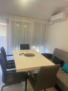 a living room with a table and chairs and a couch at Romantika 4 in Veliko Gradište