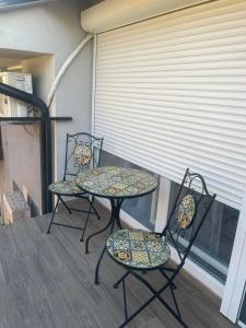 two chairs and a table on a balcony at Romantika 4 in Veliko Gradište