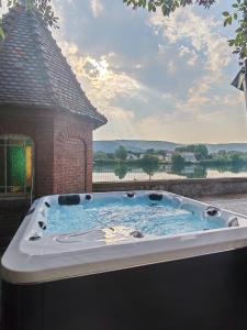 a jacuzzi tub on the back of a house at L'Escale du Rhône de 1 à 8 personnes in Saint-Vallier