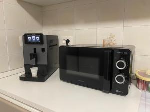 a microwave sitting on a counter next to a coffee maker at Da Paola 