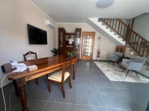 a living room with a wooden table and stairs at Da Paola 