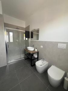 a bathroom with a toilet and a sink and a shower at Da Paola 