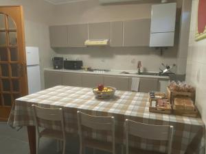a kitchen with a table with a bowl of fruit on it at Da Paola  +15 photos