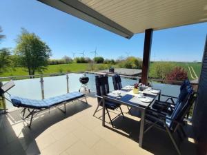 a patio with a table and chairs and a pool at Ostseebrise in Grömitz