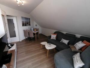 a living room with a couch and a table at Ostseebrise in Grömitz