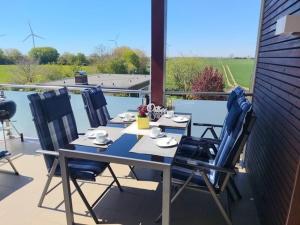 a table and chairs on a patio with a view at Ostseebrise in Grömitz +27 photos