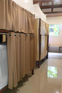 a row of curtains in a room at Hostel Mar y Bosque in Drake