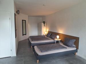 two beds in a room with two lamps on at Apartment am Gestütswegs EG 2 in Alt Krenzlin