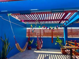 a blue wall with hammocks on a patio at Raymi House Hostel in Arica