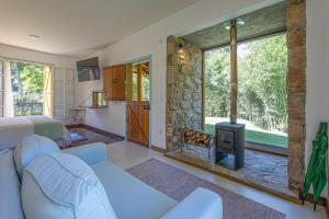 a living room with a couch and a fireplace at Fazenda Montanhas do Japi in Jundiaí
