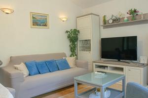 a living room with a couch and a flat screen tv at Charming Villa Katja with Private Pool and AC in All Rooms, Near Split in Omiš