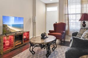 a living room with a fireplace and a tv at Mid-City Serenity Oasis in Huntsville