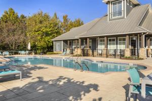 a swimming pool in front of a house at Mid-City Serenity Oasis in Huntsville
