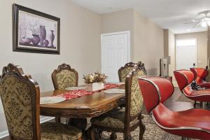 a dining room with a wooden table and chairs at Mid-City Serenity Oasis in Huntsville