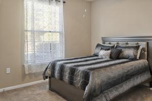 a bedroom with a bed and a window at Mid-City Serenity Oasis in Huntsville +25 photos