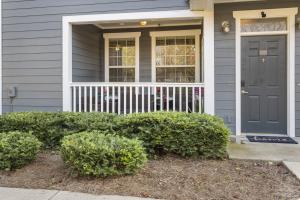 a house with a blue door and some bushes at Mid-City Serenity Oasis in Huntsville