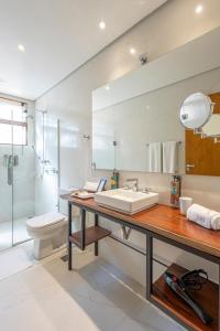 a bathroom with a sink and a toilet and a mirror at Fazenda Montanhas do Japi in Jundiaí +44 photos