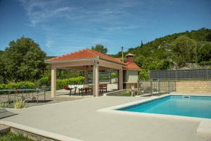 a gazebo with a swimming pool and a patio at Charming Villa Katja with Private Pool and AC in All Rooms, Near Split in Omiš
