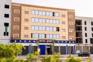 a brick building with a police car parked in front of it at Lagoon House Dakhla in Dakhla +99 photos