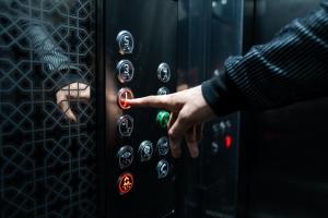 a person pressing a button on an elevator at Lagoon House Dakhla in Dakhla