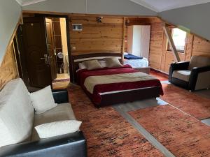 a bedroom with a bed and a couch at Yedigoller Hotel & Restaurant in Uzungöl