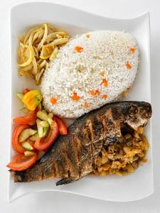 a plate of food with rice and a fish at Timonier Ecolodge in Mar Lodj +53 photos