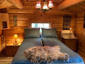 a bedroom with a bed in a log cabin at Log cabin in rural surroundings in Stjoerdal