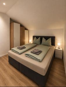 a bedroom with a large bed with two pillows on it at Haus Antonia in Zams