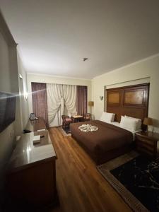 a hotel room with a bed and a couch at Cleopatra Hotel in Cairo