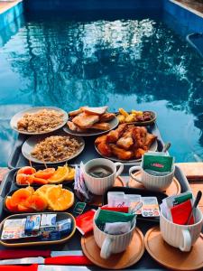 a tray of food on a table next to a pool at Iguazú Garden Lodge in Puerto Iguazú